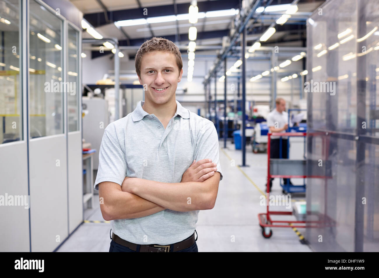 Portrait of worker with arms folded in engineering factory Stock Photo