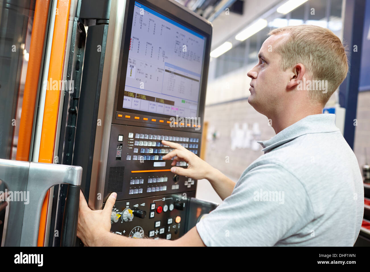 Worker looking at computer monitor in engineering factory Stock Photo