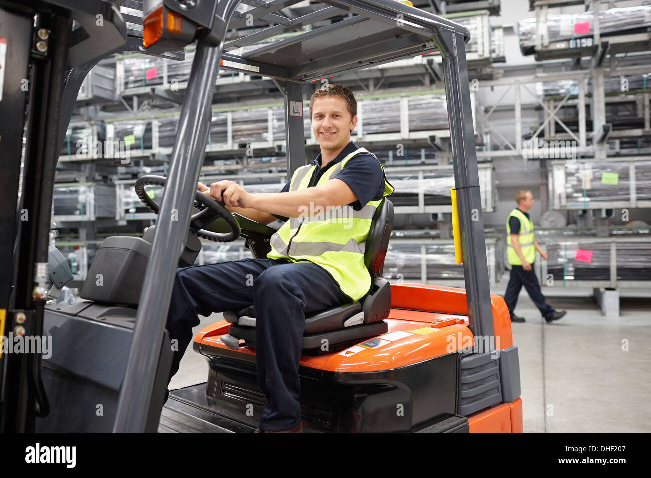 Forklift truck driver in engineering warehouse Stock Photo 62411111