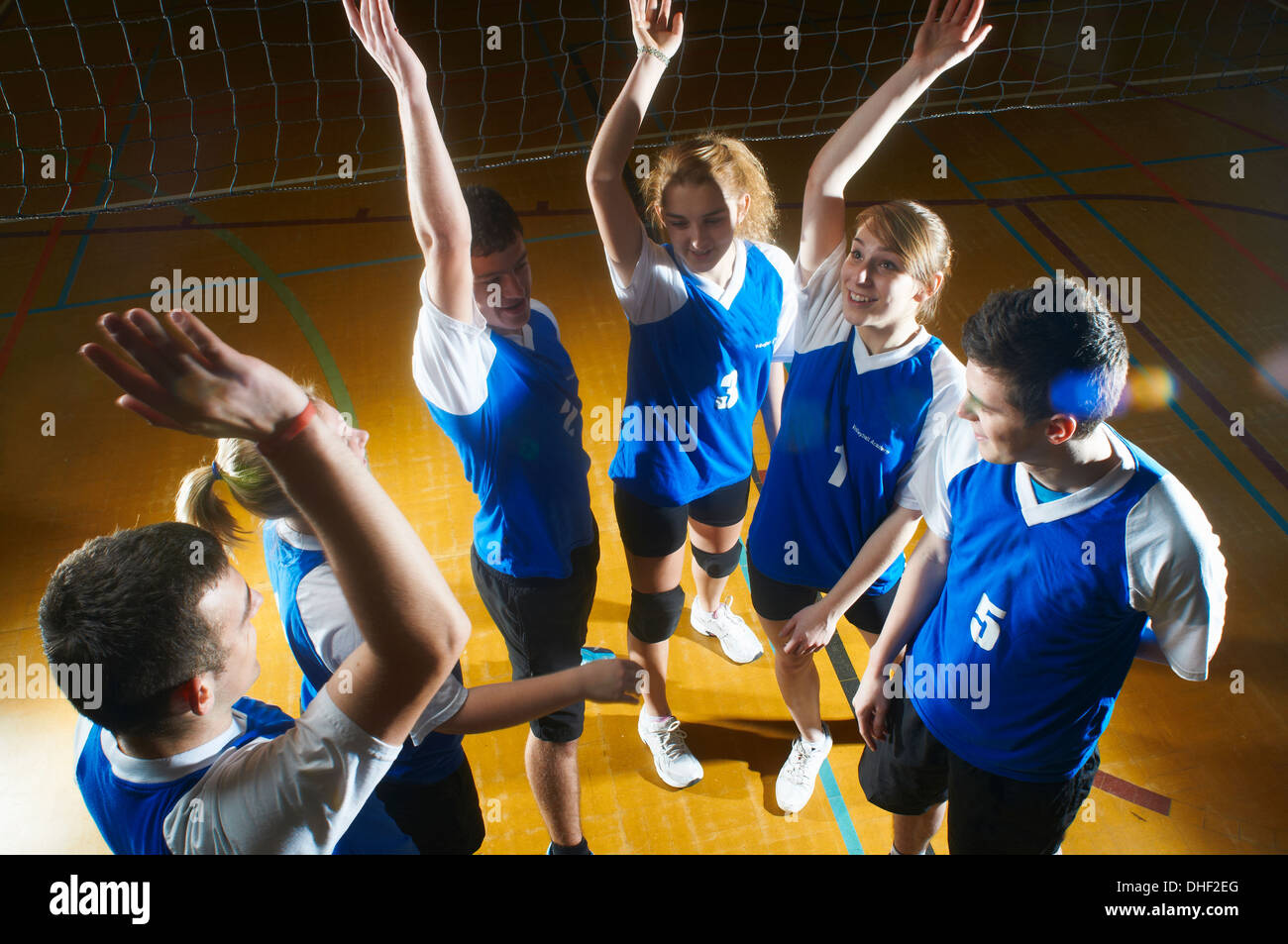 Volleyball team doing high fives Stock Photo