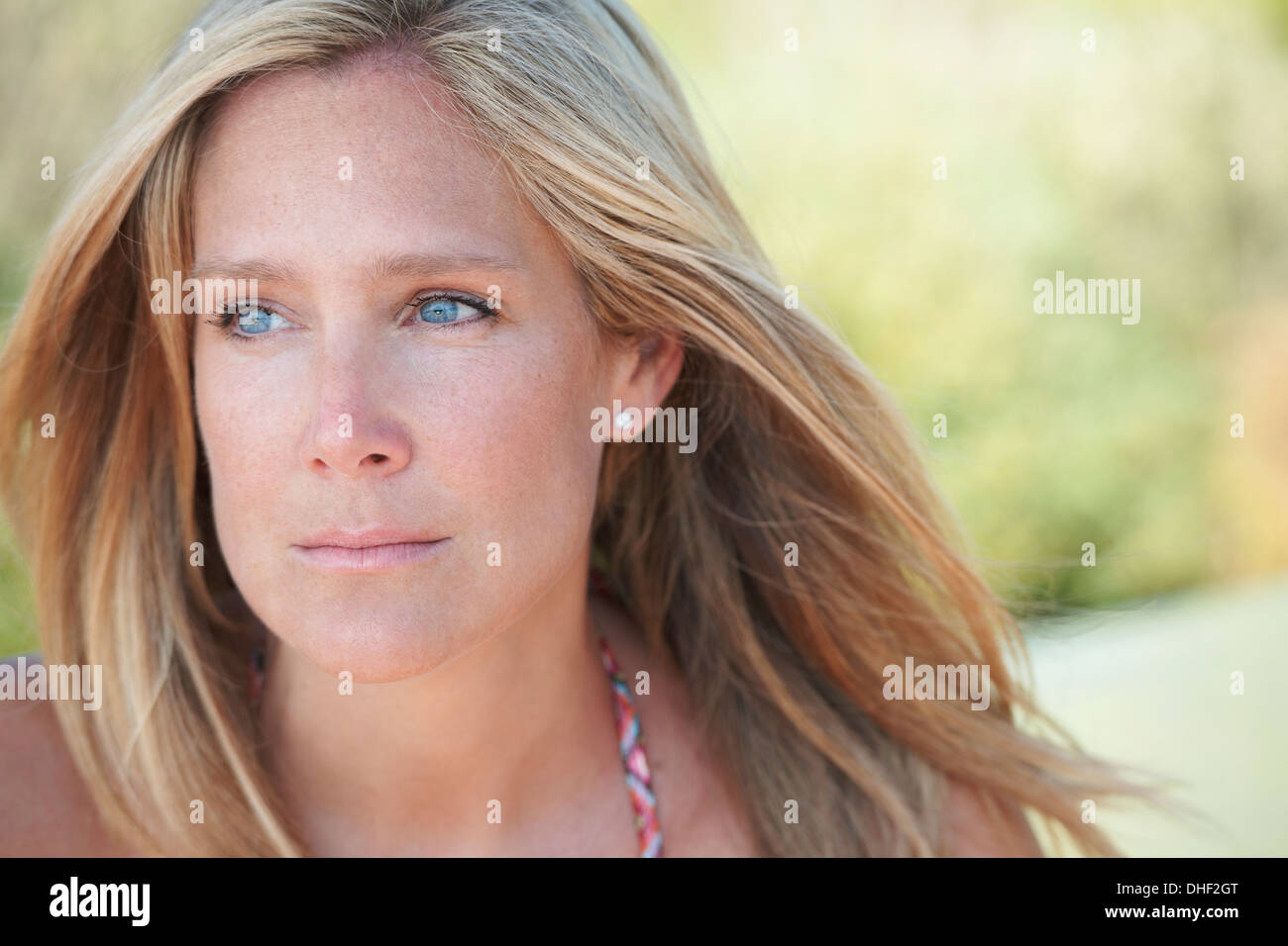 Portrait of mature woman with blonde hair, looking away Stock Photo