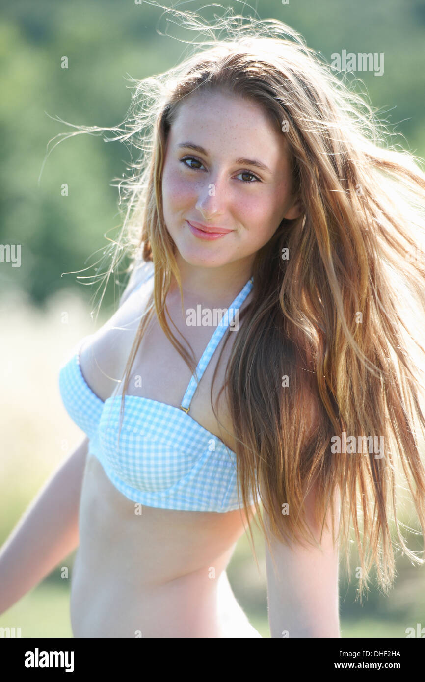 Portrait of teenage girl wearing bikini top Stock Photo - Alamy