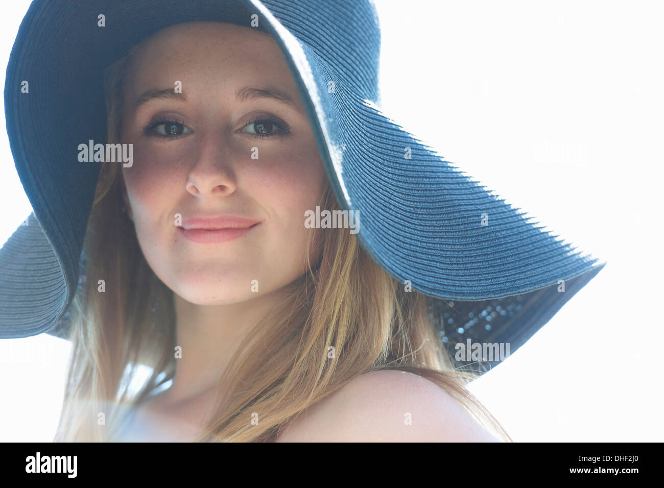 Portrait of teenage girl wearing blue sunhat Stock Photo