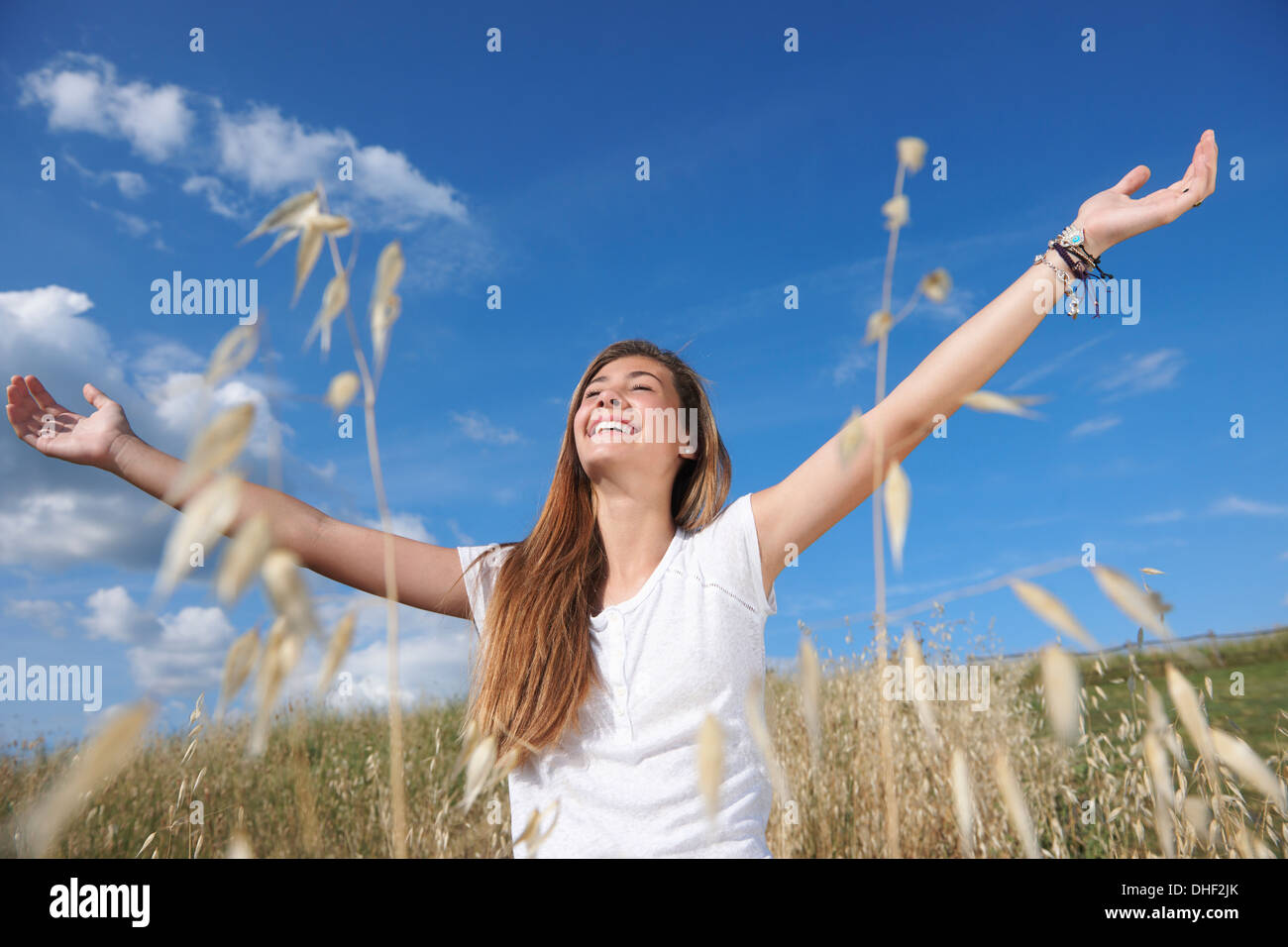 Teenage girl in field with arms out, Tuscany, Italy Stock Photo