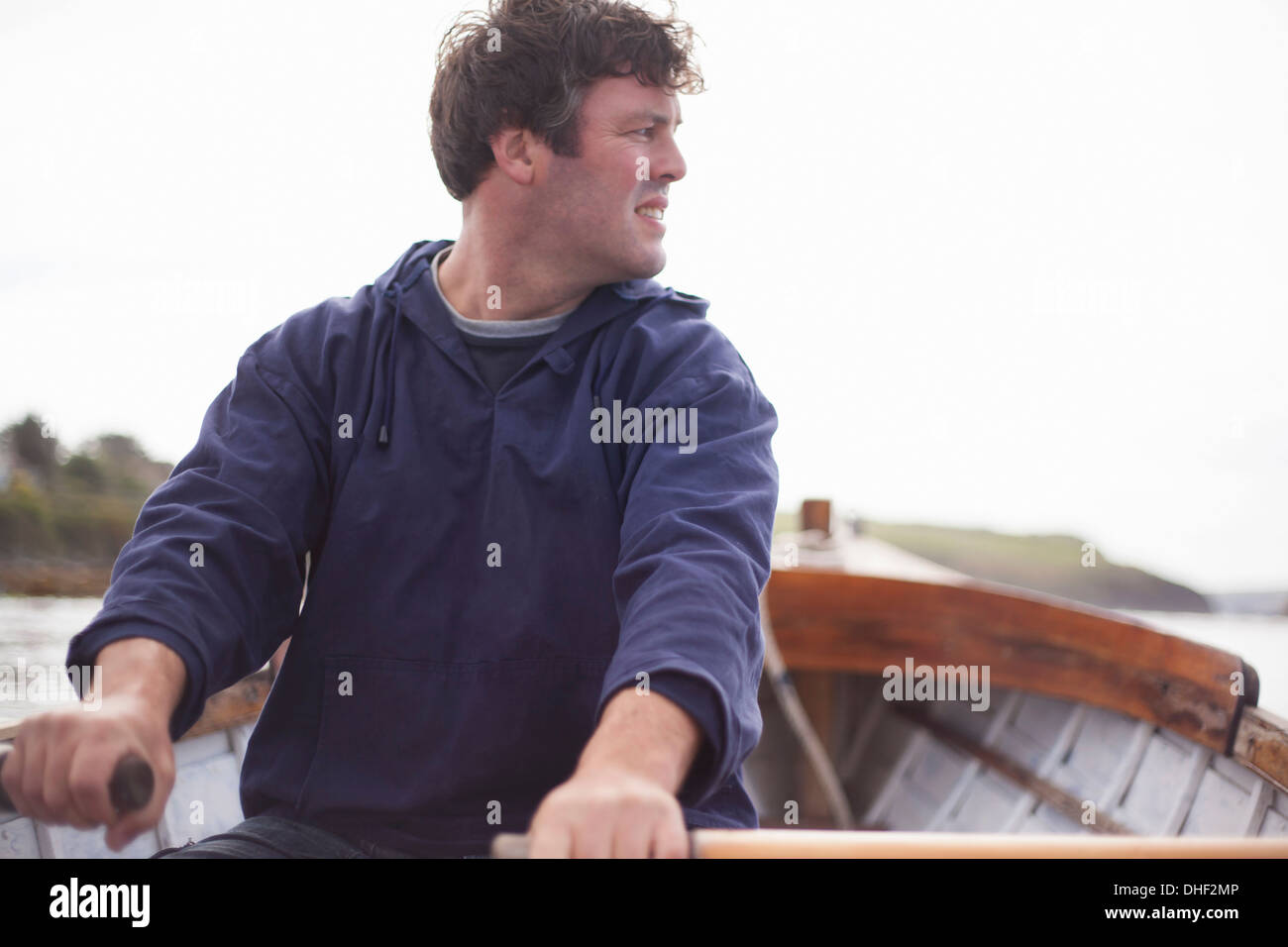 Portrait of man rowing in boat, Wales, UK Stock Photo