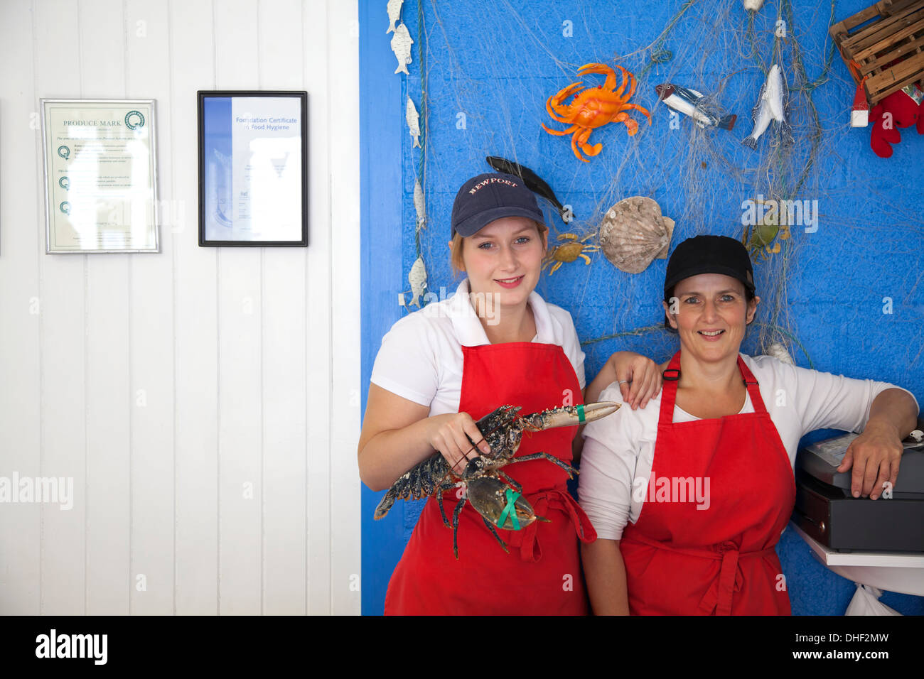 Women holding fresh lobsters Stock Photo