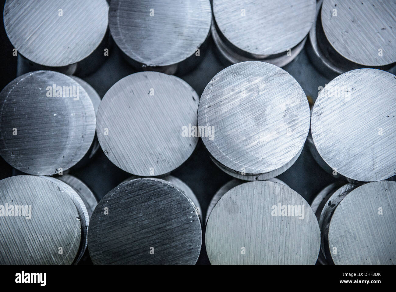 Stacks of raw and unworked steel discs in factory, overhead view Stock Photo
