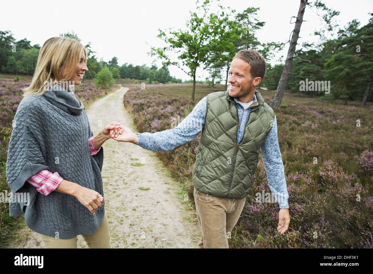 Mid adult couple holding hands on path Stock Photo