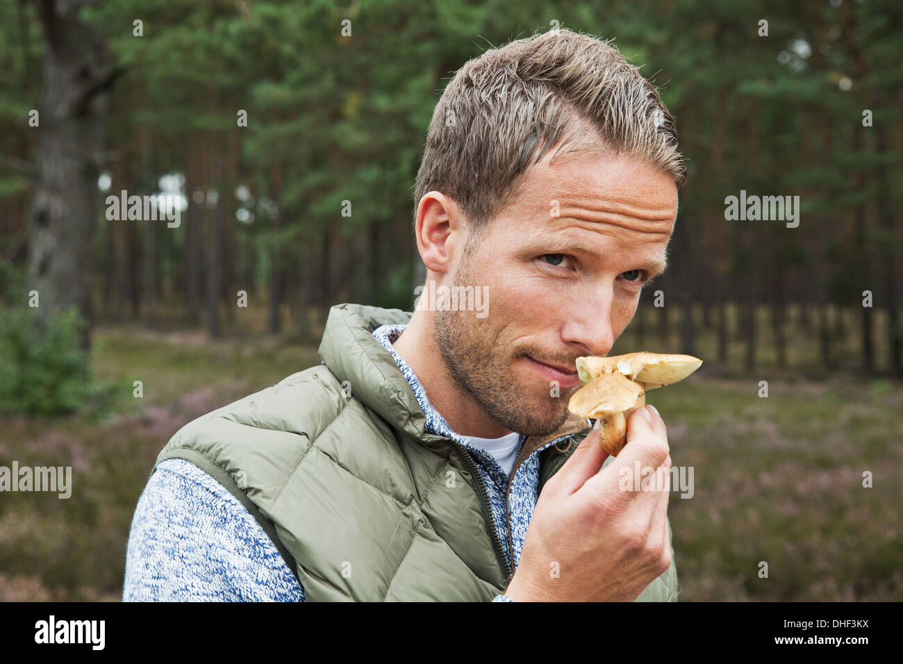 Mid adult man smelling mushroom Stock Photo