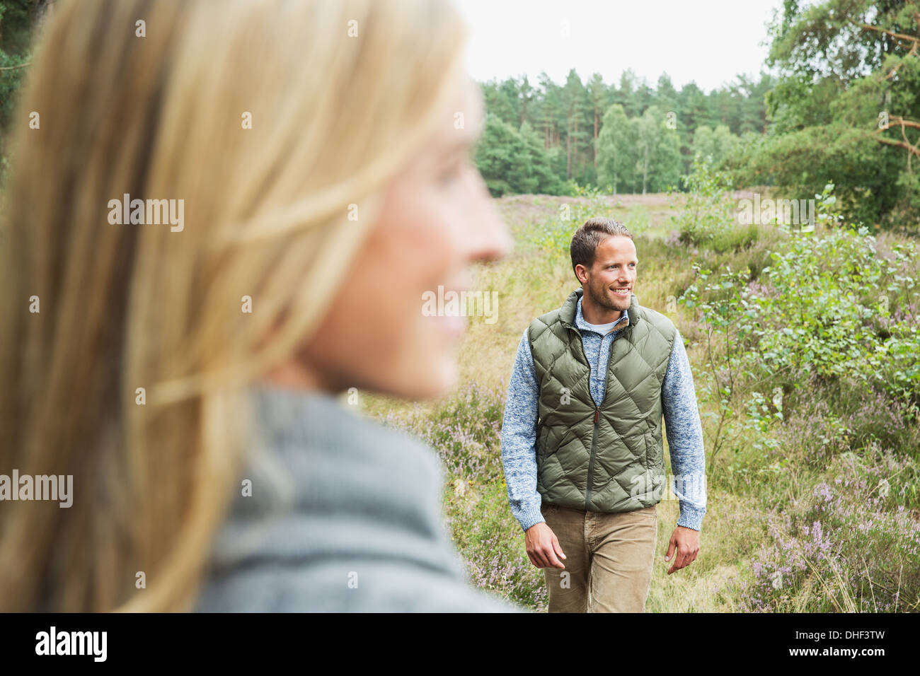 Mid adult man looking away, woman blurred in foreground Stock Photo