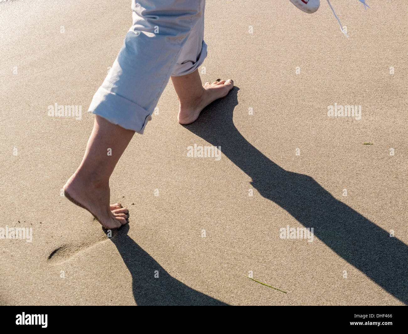 Walking in the sand of a beach Stock Photo Alamy
