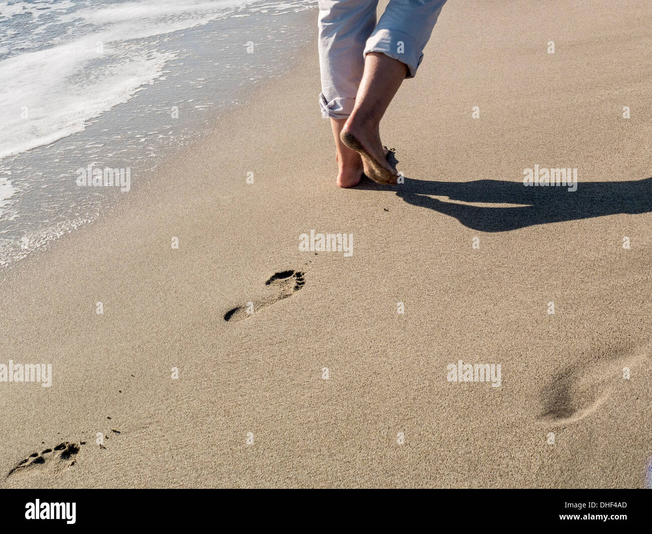 Walking in the sand of a beach Stock Photo Alamy