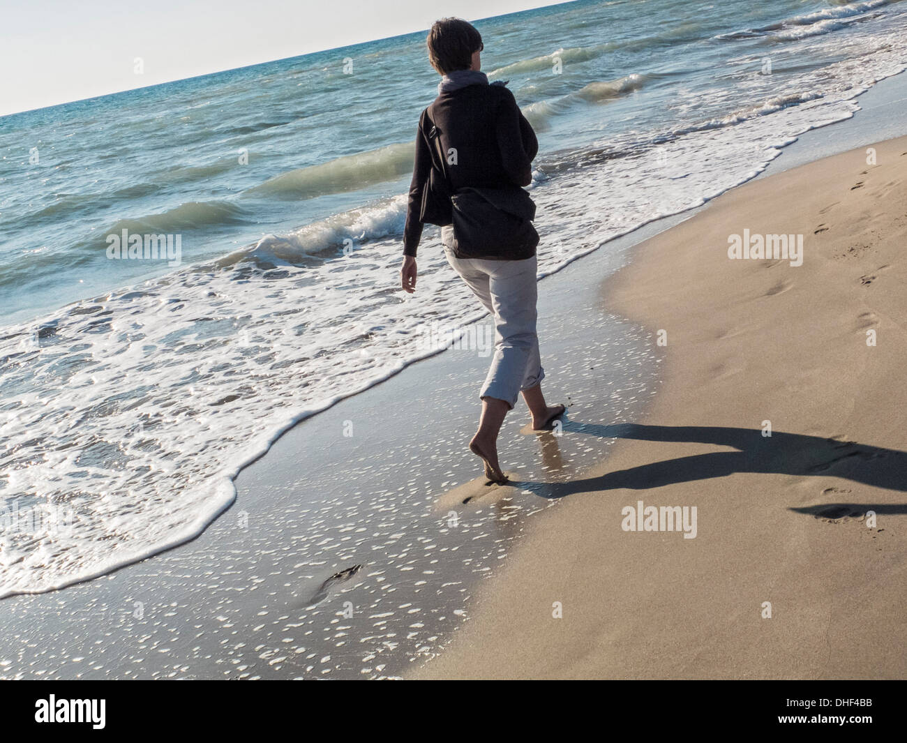 Walking in the sand of a beach Stock Photo Alamy