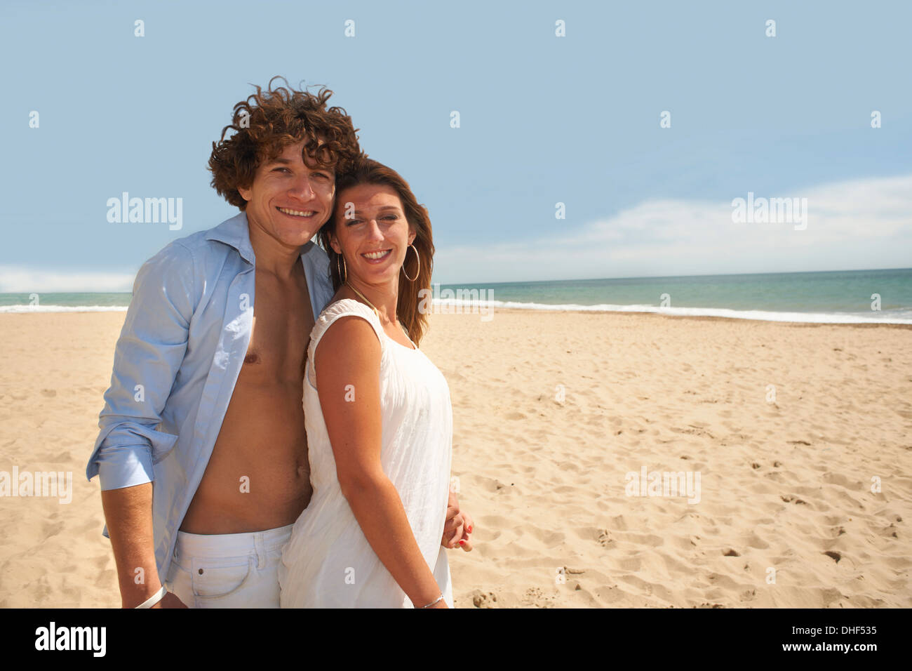 Couple posing for camera on beach Stock Photo