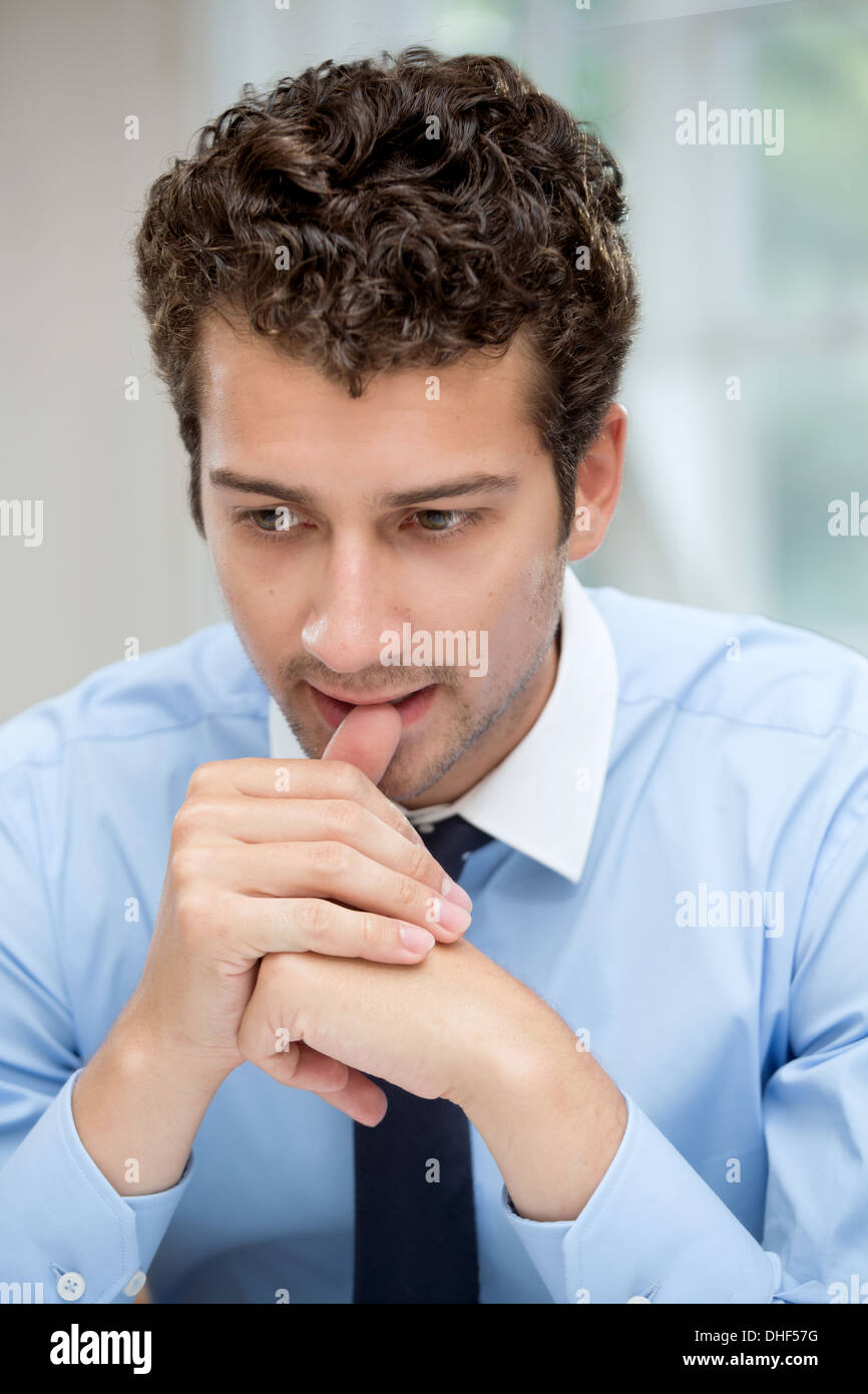 Young man in deep thought Stock Photo Alamy