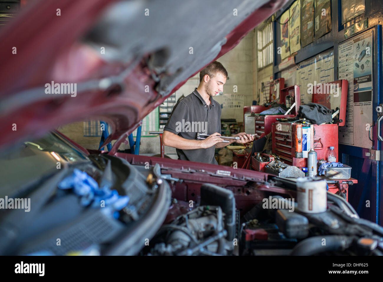 Mechanic holding tool in garage Stock Photo