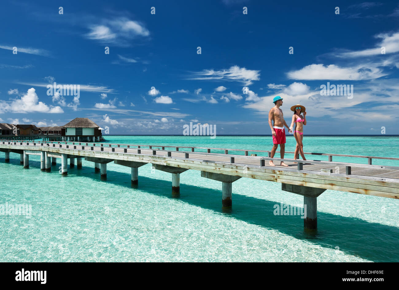Couple on a beach jetty at Maldives Stock Photo