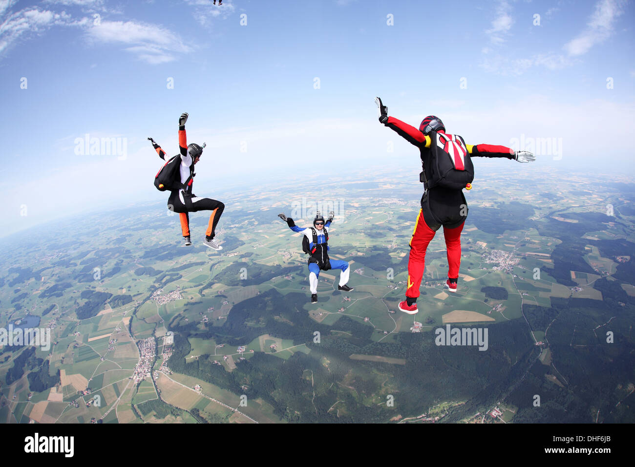 Three skydivers free falling above Leutkirch, Bavaria, Germany Stock Photo