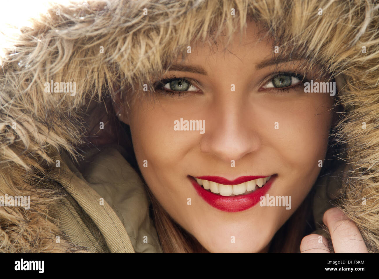 Close up portrait of young woman in parka hood Stock Photo
