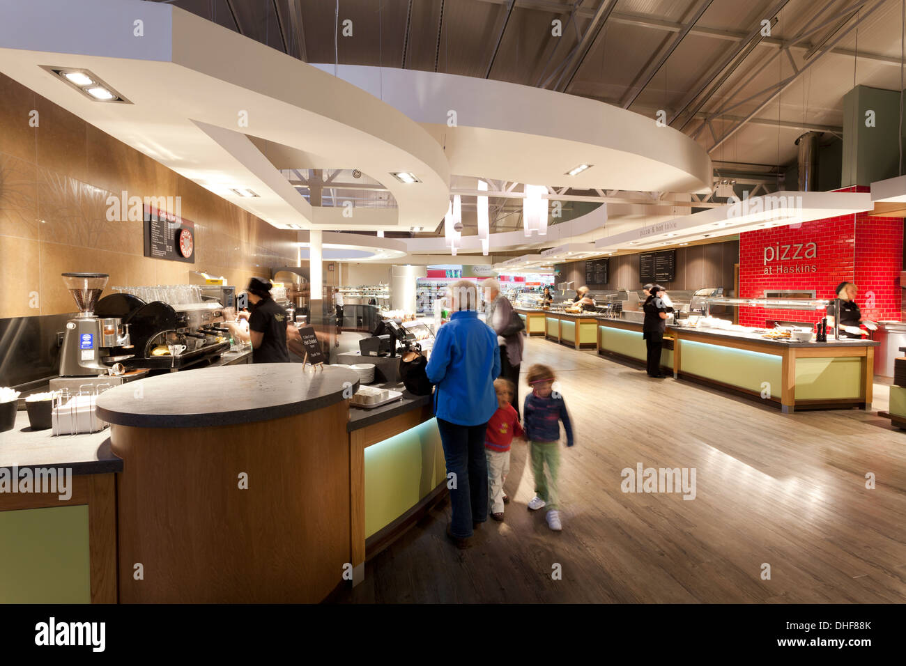 Family group at servery of large self service restaurant. Stock Photo