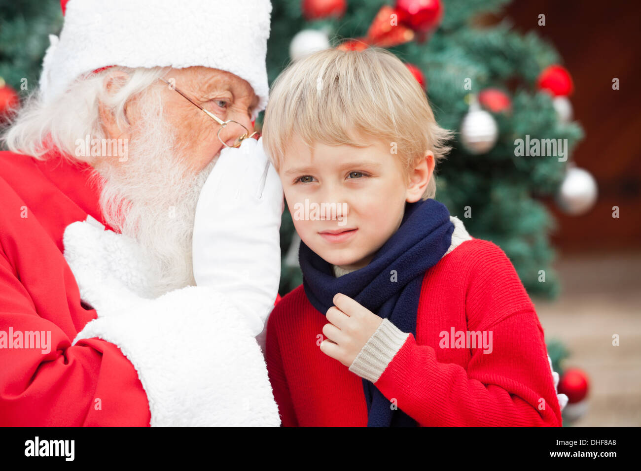 Santa Claus Whispering In Boy's Ear Stock Photo - Alamy