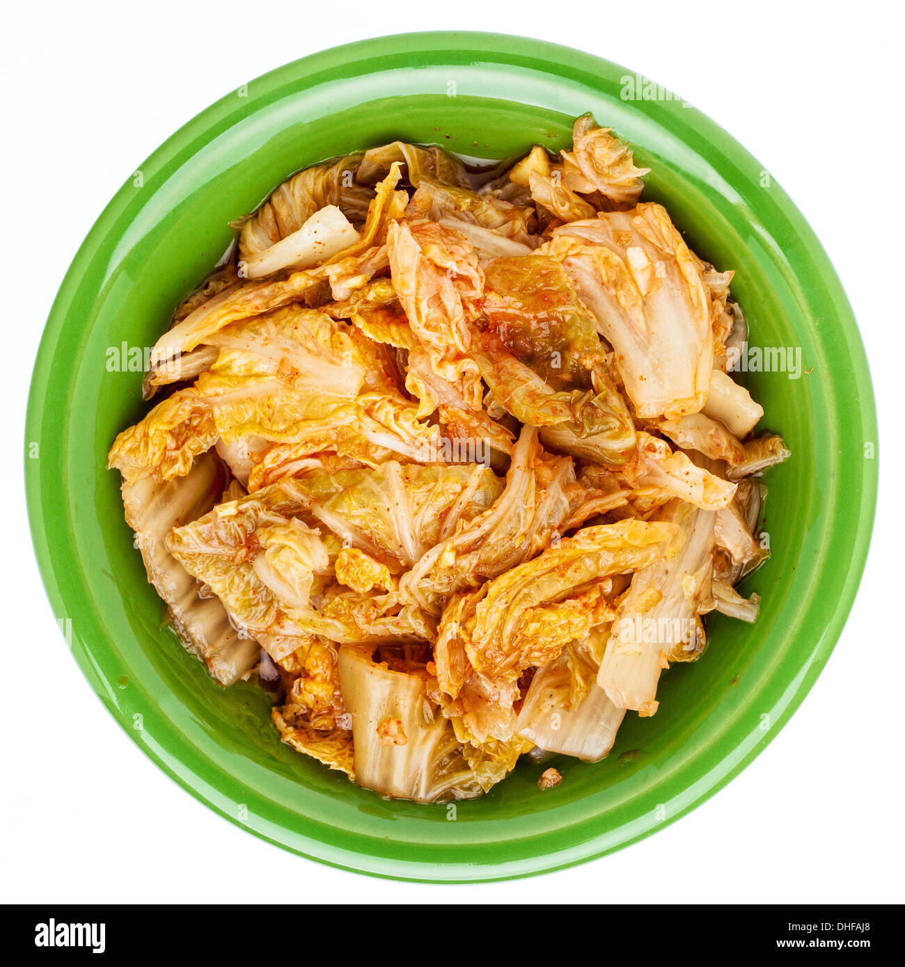 fermented napa cabbage with garlic and onion - a tradition Korean kimchi dish in a small ceramic bowl, isolated on white Stock Photo
