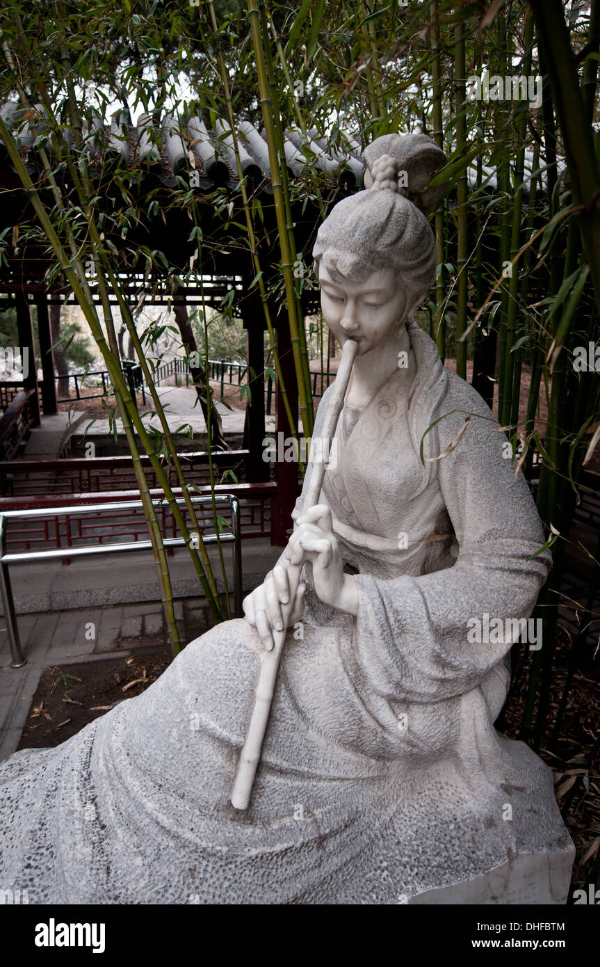 Statue of woman playing on chinese bamboo  flute in Zizhuyuan Park known as Purple or Black Bamboo Park in Beijing, China Stock Photo