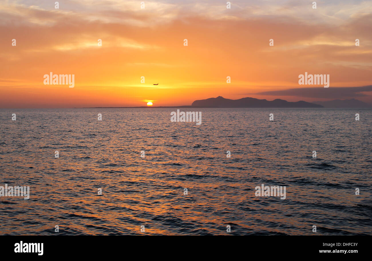 Sunset view 'sun in the sky' sun sky seascape landscape 'orange color' orange yellow island sea water horizon cloudy nobody Stock Photo