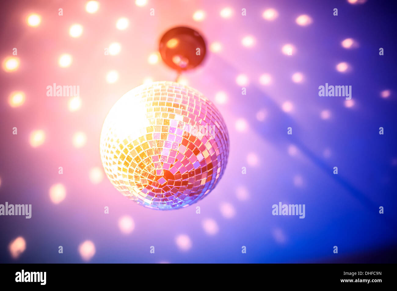 Colorful disco ball rotating light spot reflections on wall and floor Stock  Photo - Alamy