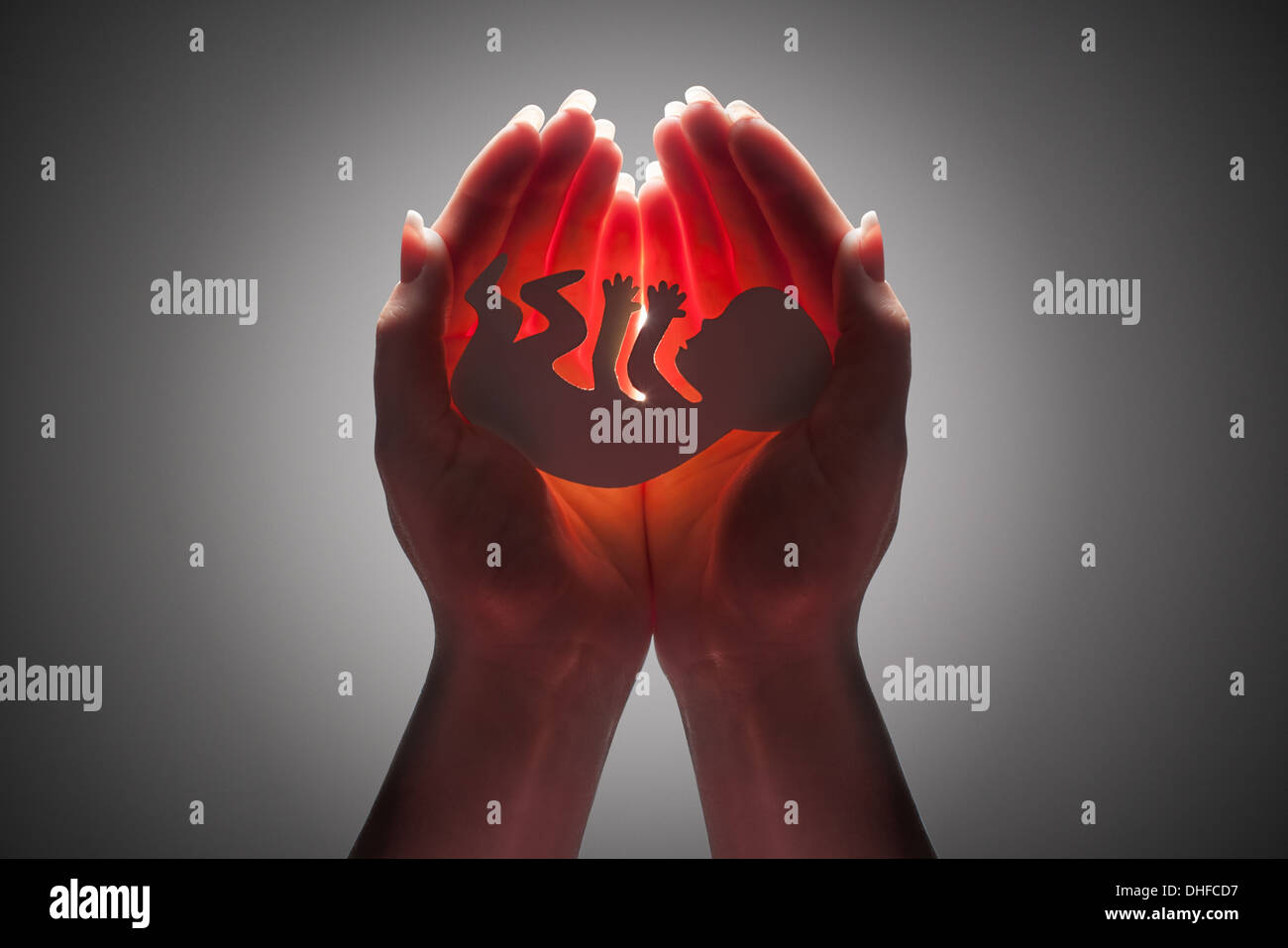 embryo silhouette in woman hand Stock Photo