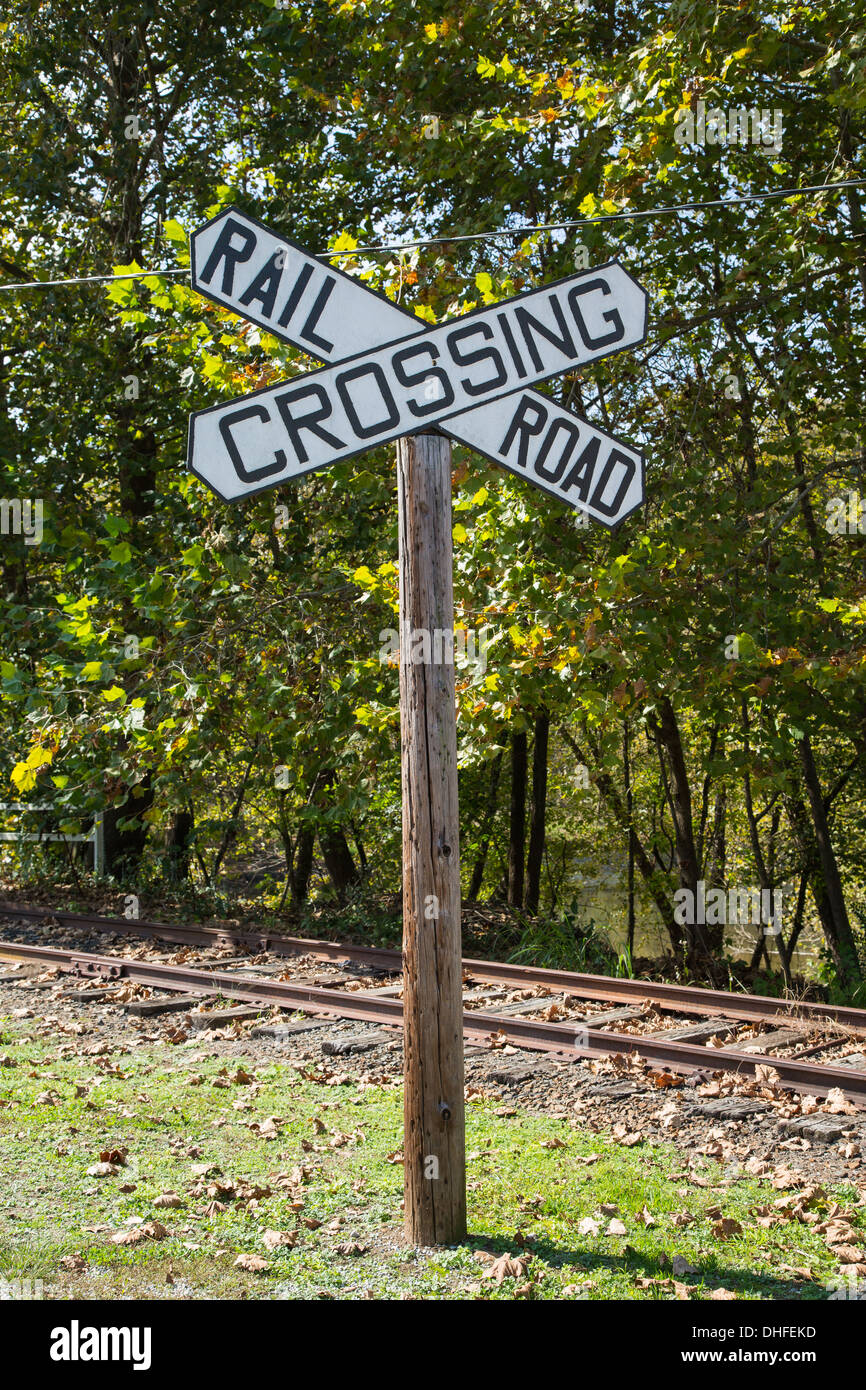 This large railroad crossing sign stands next to an unused track in North Carolina. Stock Photo