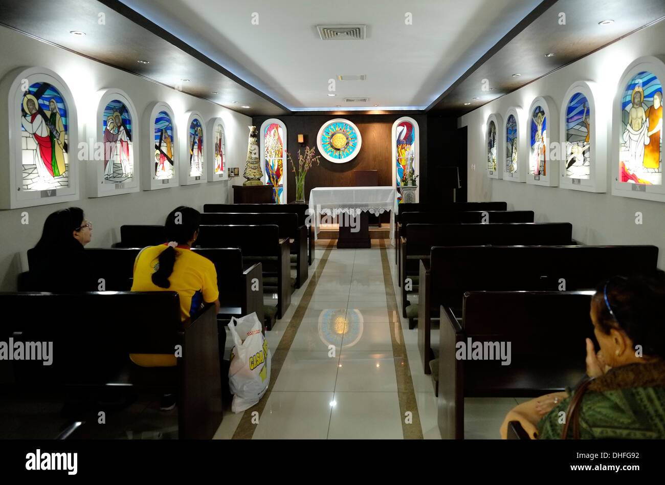 Christian passengers praying in a small Catholic parish in Tocumen International Airport in Panama city Panama Stock Photo
