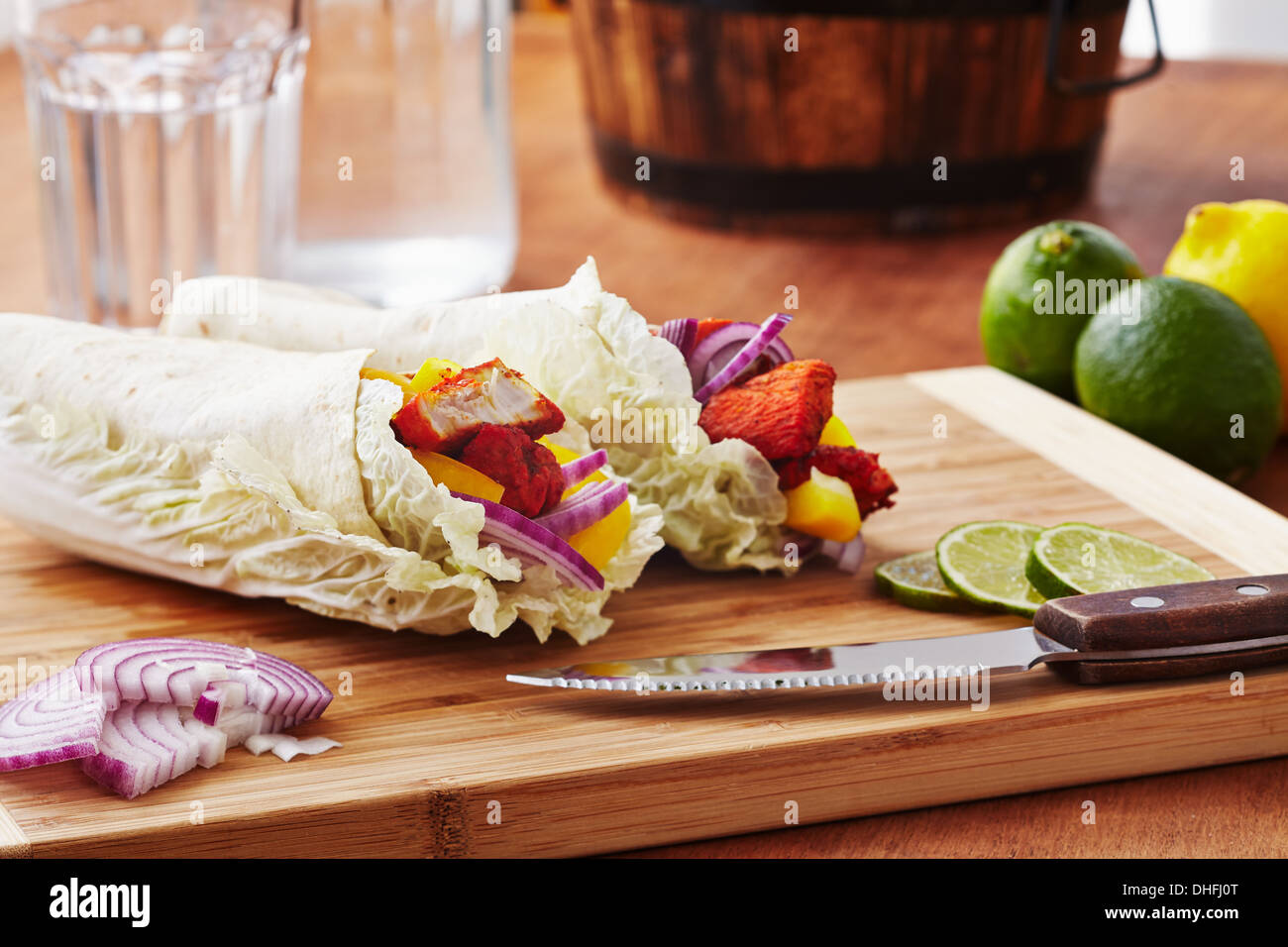 tandoori masala spiced tortilla wraps with lettuce, peppers, lime and onion  Stock Photo