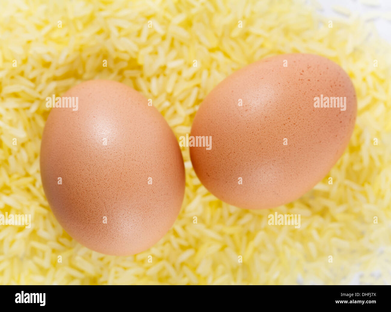 two chicken eggs on yellow rice, close up Stock Photo