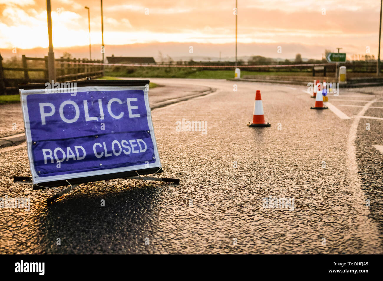 Police road closed sign and traffic cones seal off a road following an incident Stock Photo