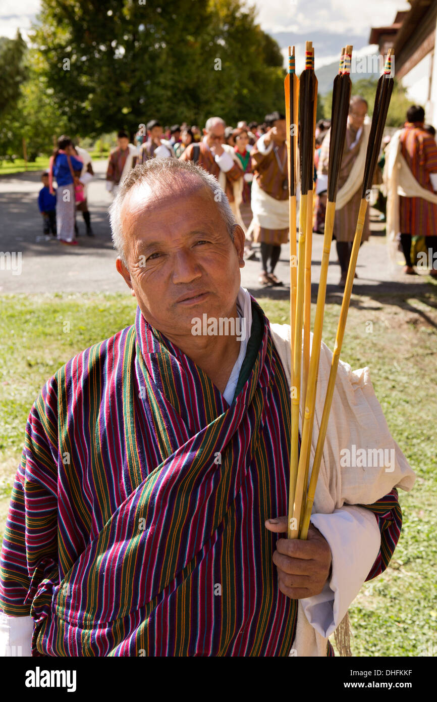 Bhutan, Thimpu Dzong, annual Tsechu, vendor wearing Gho selling traditional arrows Stock Photo