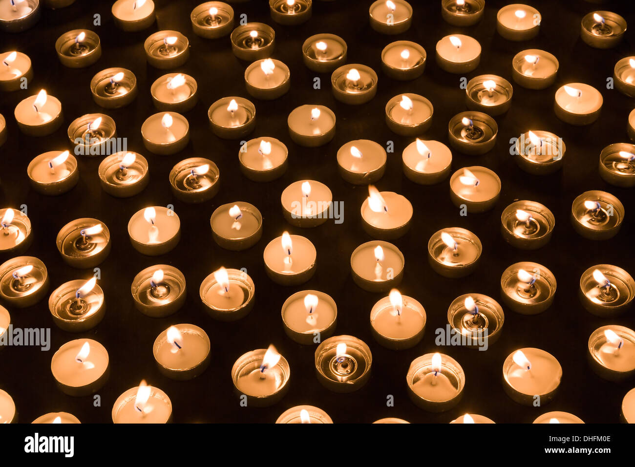 Large group of burning candles at a black background Stock Photo