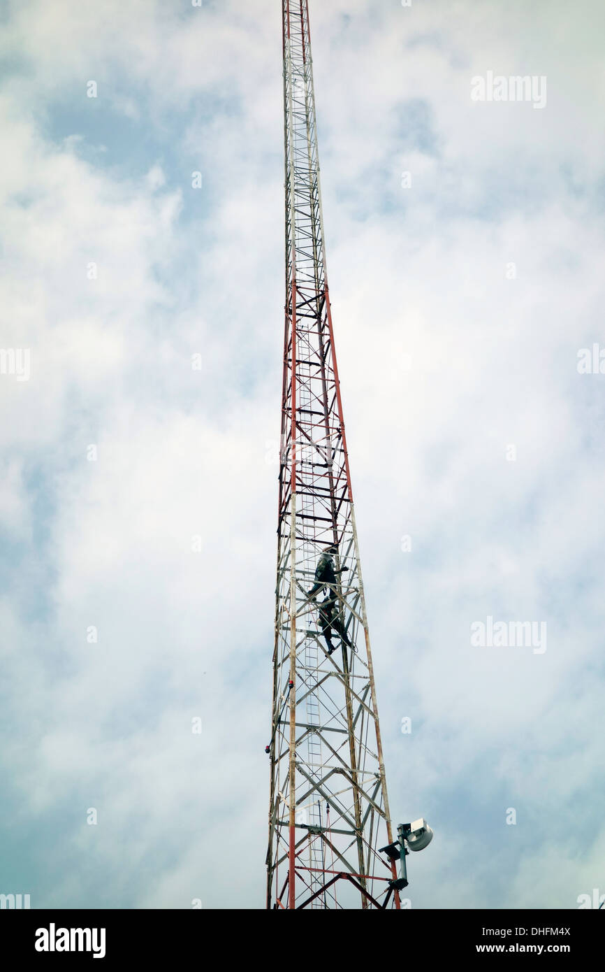 man climbing communications tower Stock Photo Alamy