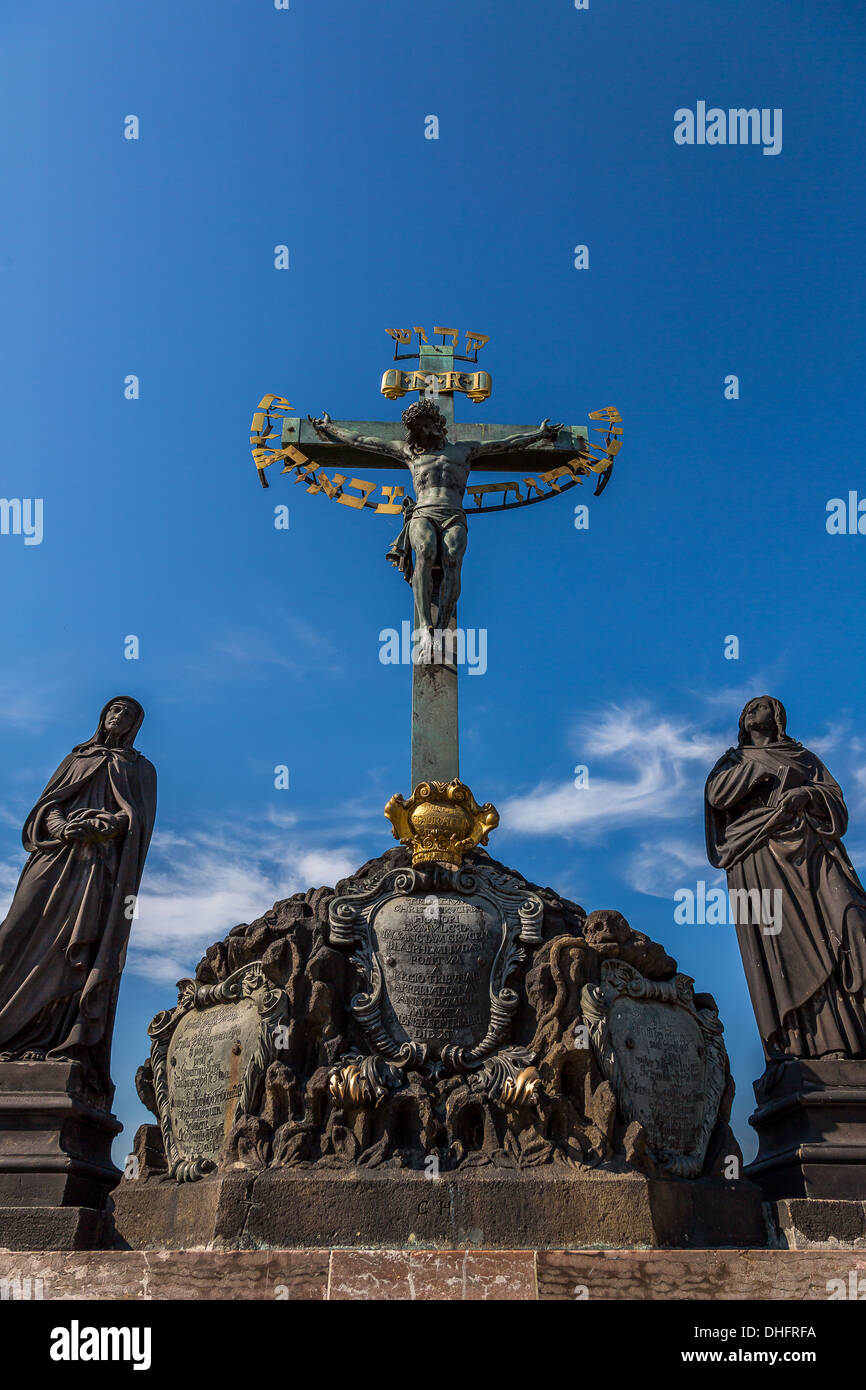 17th Century Crucifixion statue with Hebrew lettering in Charles Bridge Prague, Czech Republic Stock Photo