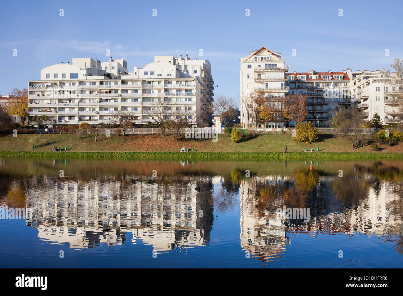 Lakeside modern apartment buildings with reflections on water in
