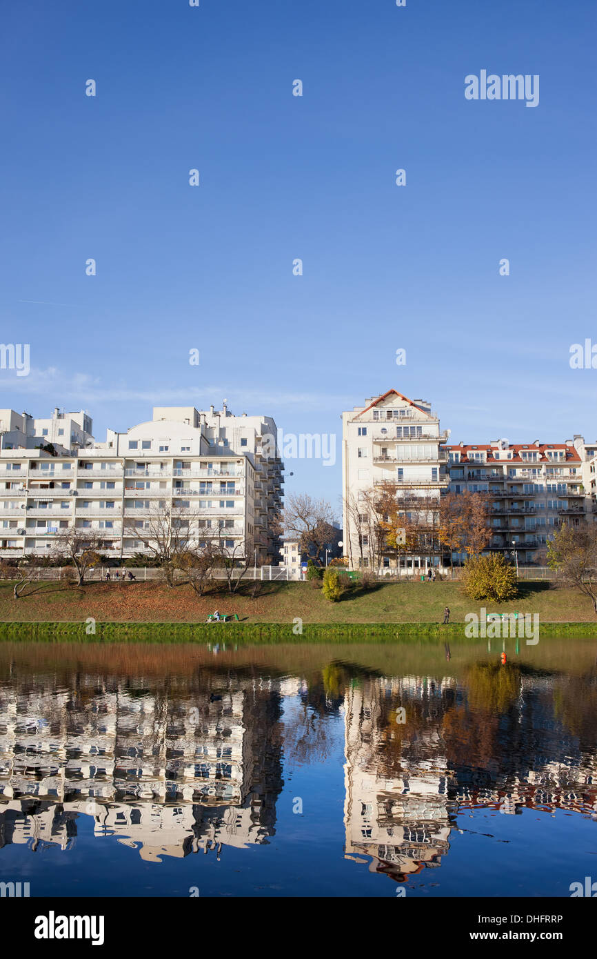 Lakeside modern apartment buildings with reflections on water in Warsaw