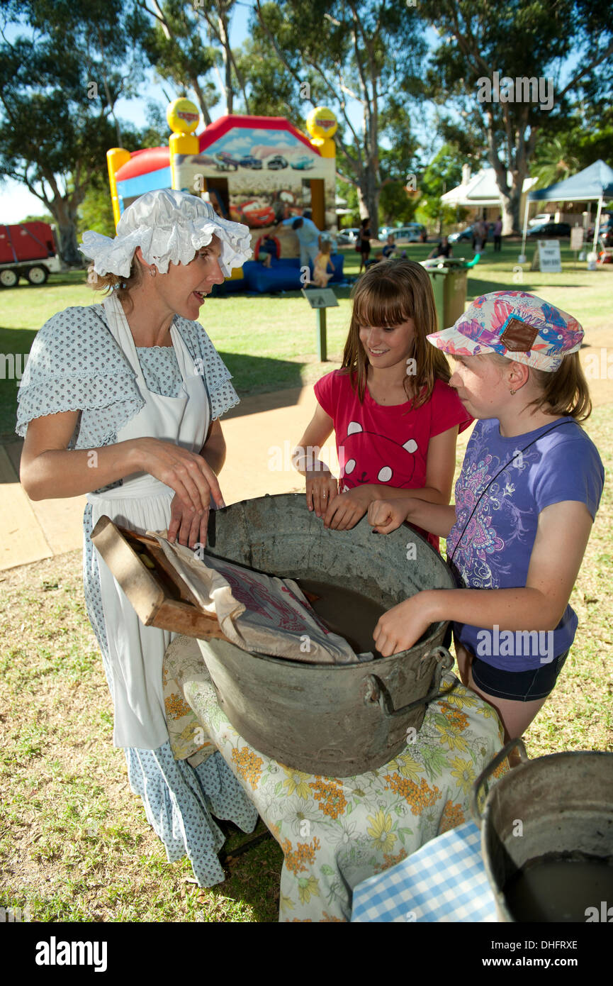 Children washing clothes using washboard at Pioneer Fair, Guildford