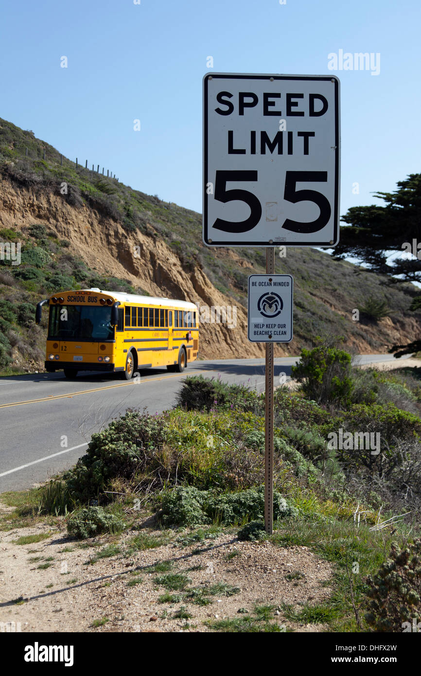 Yellow School Bus & 55 Speed Limit Sign, Cabrillo Highway, California State Route 1, California, USA. Stock Photo