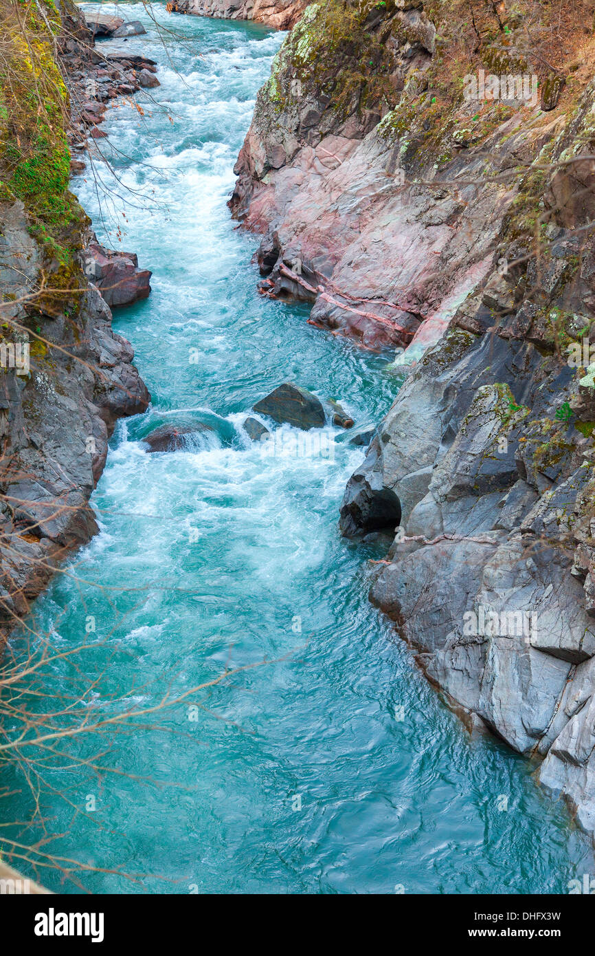 Mountain stream flowing through the red rocks Stock Photo