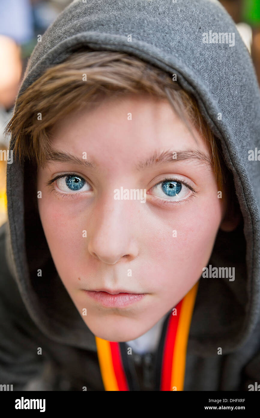 portrait of a teenage boy with grey hoodie sweatshirts, after sports with red face. Stock Photo