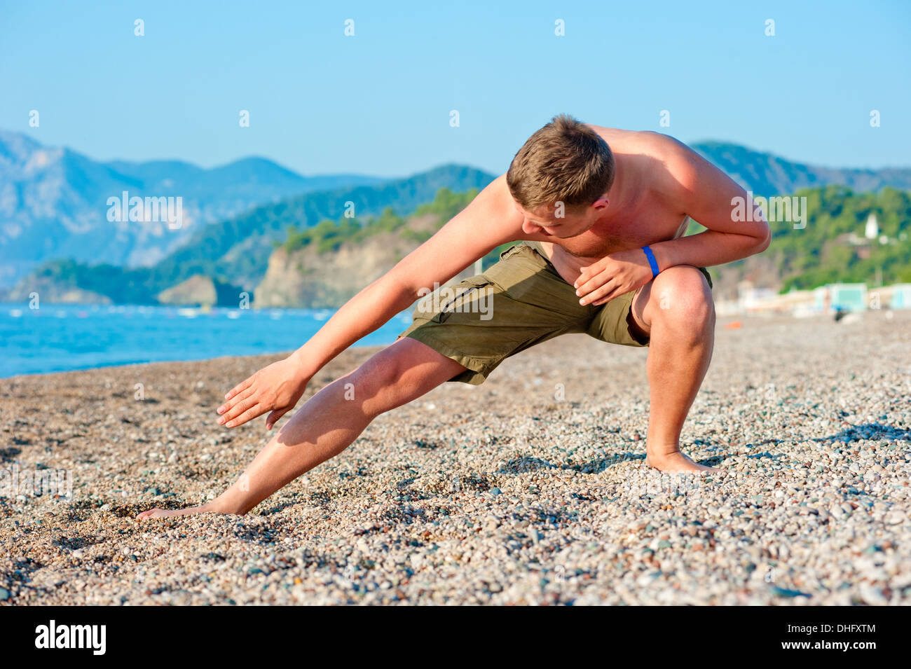 man playing sports on the beach at dawn Stock Photo