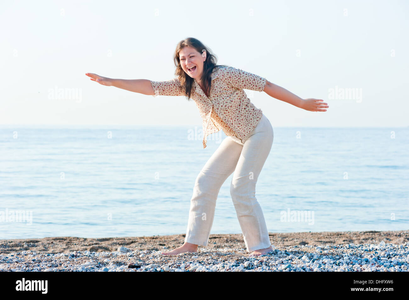 young girl on the beach fooling around Stock Photo