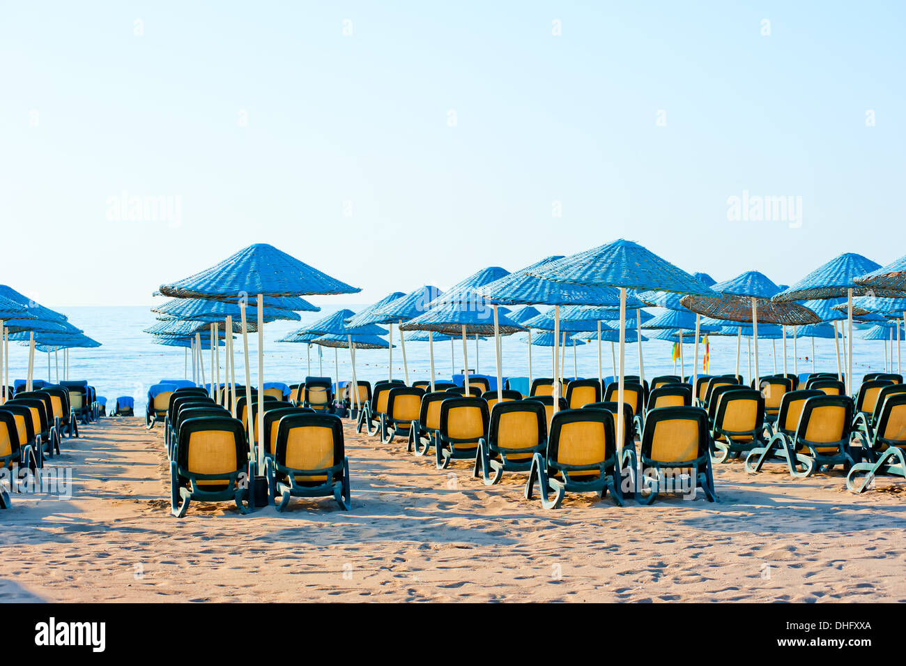 neat rows of sun loungers on the beach Stock Photo