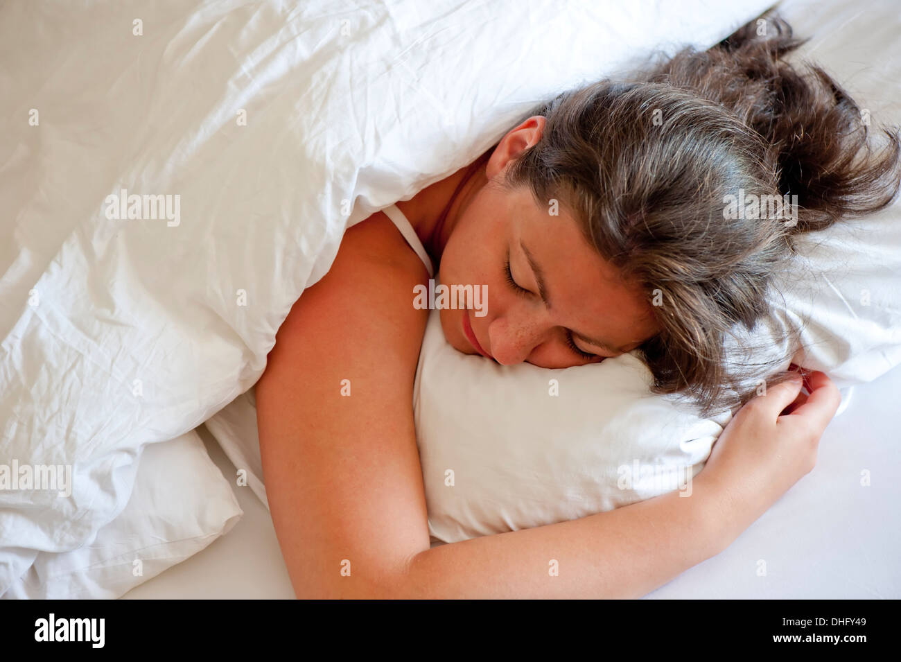 girl sleeping on his stomach hugging pillow Stock Photo Alamy