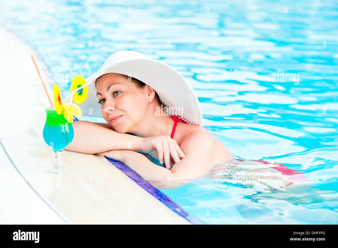 Woman in bikini and hat in the pool Stock Photo